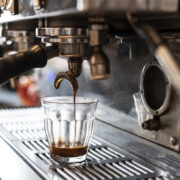 Close up glass on commercial espresso machine.